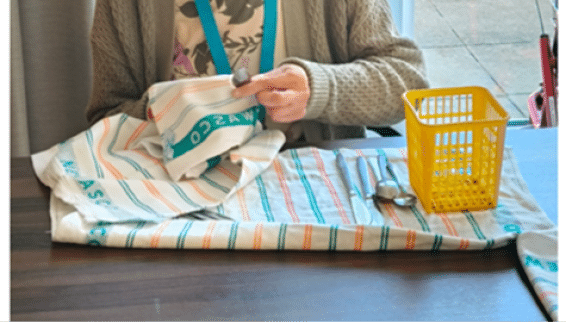 A person is cutting a piece of fabric on a table. AI generated content